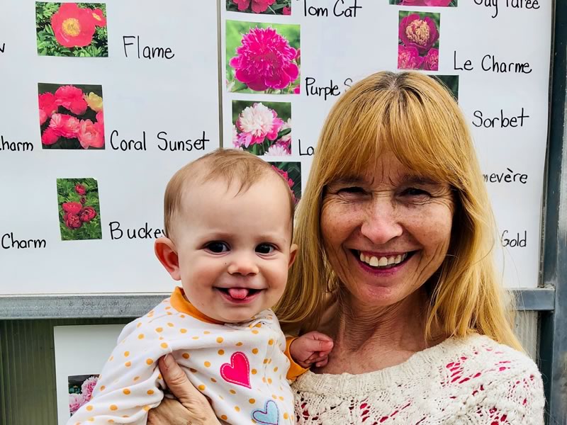Inge and baby Primrose enjoying the Peonies